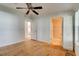 Bright bedroom featuring a ceiling fan, closet, and en-suite bathroom with space to personalize at 526 Powers Ave, Port Orange, FL 32127