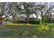 Charming home exterior with lush greenery, a screened porch, and a well-maintained lawn at 526 Powers Ave, Port Orange, FL 32127