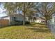 Well-maintained home surrounded by a lush green lawn and mature trees at 526 Powers Ave, Port Orange, FL 32127