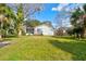 Charming single-story home with well-maintained lawn, mature landscaping, and a screened-in porch at 526 Powers Ave, Port Orange, FL 32127