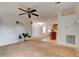Spacious interior with an open layout, ceiling fan, and kitchen view, awaiting your personal design touches at 526 Powers Ave, Port Orange, FL 32127