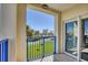 Balcony with blue railings and a view of lawn and buildings at 5300 S Atlantic Ave # 3-301, New Smyrna Beach, FL 32169
