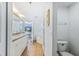 Bathroom with double vanity sinks, toilet and glass-door shower at 5300 S Atlantic Ave # 3-301, New Smyrna Beach, FL 32169