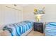 Cozy bedroom showcasing twin beds, closet space and beachy wall decor at 5300 S Atlantic Ave # 3-301, New Smyrna Beach, FL 32169