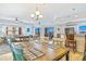 Dining area seamlessly connects to the living room and kitchen with a table and seating for six at 5300 S Atlantic Ave # 3-301, New Smyrna Beach, FL 32169
