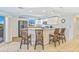 Well-lit kitchen with white cabinets, stainless steel appliances, and a breakfast bar with seating at 5300 S Atlantic Ave # 3-301, New Smyrna Beach, FL 32169