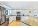 Bright kitchen with white cabinetry, stainless steel appliances, and a breakfast bar area at 5300 S Atlantic Ave # 3-301, New Smyrna Beach, FL 32169