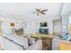 Spacious living room and dining area with stylish furniture, a ceiling fan, and tile flooring at 5300 S Atlantic Ave # 3-301, New Smyrna Beach, FL 32169