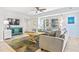 Cozy living room with tile flooring, modern furnishings and large windows letting in plenty of natural light at 5300 S Atlantic Ave # 3-301, New Smyrna Beach, FL 32169