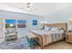 Comfortable main bedroom with blue walls, tiled floor and a view of the city at 5300 S Atlantic Ave # 3-301, New Smyrna Beach, FL 32169
