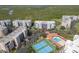 An aerial view of the condo community featuring building 7, tennis courts and an outdoor pool at 5300 S Atlantic Ave # 7-307, New Smyrna Beach, FL 32169