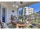 Inviting balcony with a round table, comfortable chairs, and beautiful views at 5300 S Atlantic Ave # 7-307, New Smyrna Beach, FL 32169