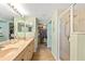 Expansive bathroom featuring double vanity, glass enclosed shower, and a walk-in closet for ample storage at 5300 S Atlantic Ave # 7-307, New Smyrna Beach, FL 32169