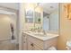 This bathroom offers a bright vanity with decorative accents and seamless access to an adjoining room at 5300 S Atlantic Ave # 7-307, New Smyrna Beach, FL 32169