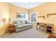 Cozy bedroom with a comfortable sofa, desk, and bright natural light at 5300 S Atlantic Ave # 7-307, New Smyrna Beach, FL 32169
