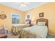 Comfortable bedroom featuring two twin beds, a ceiling fan, and a window with shutters at 5300 S Atlantic Ave # 7-307, New Smyrna Beach, FL 32169