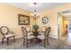 Cozy dining area with a round glass table, comfortable seating, and elegant chandelier at 5300 S Atlantic Ave # 7-307, New Smyrna Beach, FL 32169