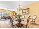 Charming dining area, open to the living room, featuring a glass-top table and modern chandelier at 5300 S Atlantic Ave # 7-307, New Smyrna Beach, FL 32169