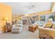 Open-concept living room connected to kitchen, featuring neutral tones, comfortable seating, and natural light at 5300 S Atlantic Ave # 7-307, New Smyrna Beach, FL 32169