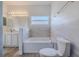 Bathroom featuring a bathtub and a large mirror at 5424 Frederick Lake Dr, Port Orange, FL 32128