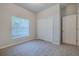 Bedroom featuring neutral carpet, window with blinds, and closet at 5424 Frederick Lake Dr, Port Orange, FL 32128