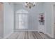 Eating area featuring a large window, chandelier, and wood floors at 5424 Frederick Lake Dr, Port Orange, FL 32128