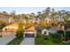 Charming single-Gathering home with lush landscaping, mature trees, and a well-manicured lawn at 5424 Frederick Lake Dr, Port Orange, FL 32128