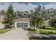 Single-story house featuring a well-maintained lawn and a two-car garage at 5424 Frederick Lake Dr, Port Orange, FL 32128