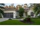 Charming single-story home featuring a well-manicured lawn and a two-car garage at 5424 Frederick Lake Dr, Port Orange, FL 32128