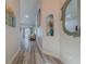 Hallway with wood floors and decorative niche that leads to a cozy living area at 5424 Frederick Lake Dr, Port Orange, FL 32128