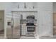 The kitchen features stainless steel appliances, light cabinets and countertops, and wood floors at 5424 Frederick Lake Dr, Port Orange, FL 32128
