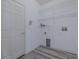 Laundry room with door, wire rack shelving, and utility connections at 5424 Frederick Lake Dr, Port Orange, FL 32128