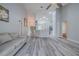 Open-concept living area featuring wood floors, high ceilings, and modern lighting fixtures at 5424 Frederick Lake Dr, Port Orange, FL 32128