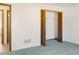 A bedroom with wood trim closet and doorways plus carpeted flooring and neutral-colored walls at 55 Bay Harbour Dr, Ponce Inlet, FL 32127