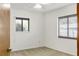 Bright bedroom featuring neutral walls, carpeted flooring, and natural light from two windows at 55 Bay Harbour Dr, Ponce Inlet, FL 32127