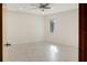 Spacious bedroom featuring tile floors, neutral walls, and a ceiling fan for added comfort at 55 Bay Harbour Dr, Ponce Inlet, FL 32127