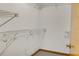 Walk in closet with white wire shelving and carpeted floor plus a wood door at 55 Bay Harbour Dr, Ponce Inlet, FL 32127
