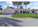 Charming single-story home with lush landscaping and a well-manicured lawn at 55 Bay Harbour Dr, Ponce Inlet, FL 32127