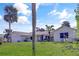 Well-maintained one-story home with a green lawn and mature trees at 55 Bay Harbour Dr, Ponce Inlet, FL 32127
