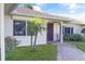 Charming front entrance with manicured landscaping and a decorative door at 55 Bay Harbour Dr, Ponce Inlet, FL 32127