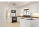 Bright kitchen with black appliances, white cabinets, and ample countertop space at 55 Bay Harbour Dr, Ponce Inlet, FL 32127