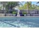 Sparkling pool with mermaid statue and lush tropical landscaping creates a serene backyard oasis at 55 Bay Harbour Dr, Ponce Inlet, FL 32127