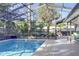 Inviting screened-in pool area, perfect for outdoor relaxation and entertaining at 55 Bay Harbour Dr, Ponce Inlet, FL 32127