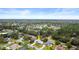 Aerial view of the house nestled in a community with mature trees, highlighting its proximity to local lakes at 6046 Burgundy Ter, Port Orange, FL 32127