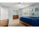 Inviting bedroom with a wooden bed, natural light, closet, and unique wall decor at 6046 Burgundy Ter, Port Orange, FL 32127