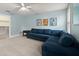 Comfortable living room with a blue sectional sofa, adjacent closet, and neutral decor at 6046 Burgundy Ter, Port Orange, FL 32127