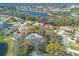 Picturesque aerial view of homes in a lakeside community, many with screened patios at 6049 Sabal Hammock Cir, Port Orange, FL 32128