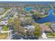 Aerial view showcases homes with pools in a lakeside community with mature trees at 6049 Sabal Hammock Cir, Port Orange, FL 32128
