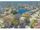 Aerial showcasing lovely homes, lush landscaping, and serene lake views in a desirable neighborhood at 6049 Sabal Hammock Cir, Port Orange, FL 32128