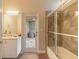 Bathroom features a glass shower, vanity, and a door leading to a sunroom at 6049 Sabal Hammock Cir, Port Orange, FL 32128